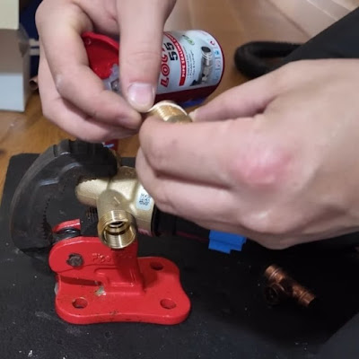 Brass pipe fitting with thread sealant by licensed Dallastown plumber